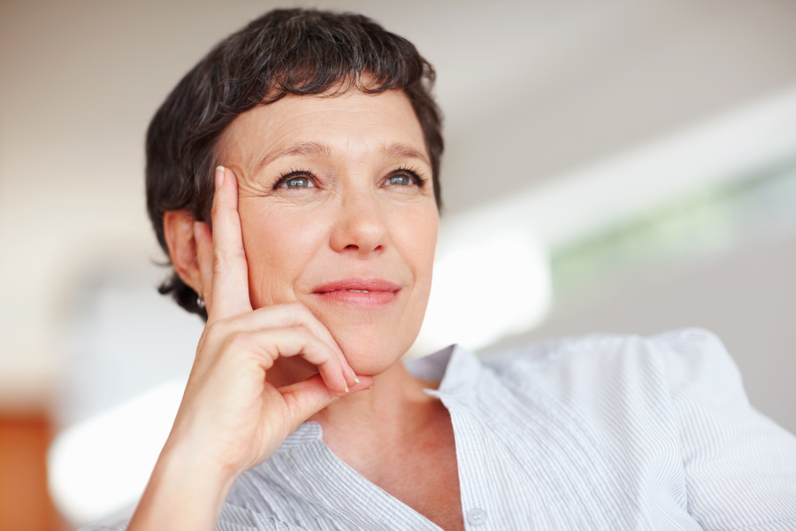 Midlife Mission Statement Blog - Midlife woman with short brown hair leaning her chin on her hand and looking contemplative